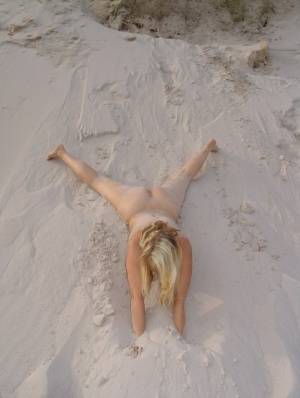Blonde amateur Sweet Susi gets totally naked on a sandy bank by herself on clubgf.com