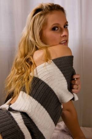 Blonde chick Joe shows her bald pussy in a sweater and black boots on clubgf.com