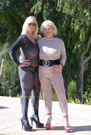 Mature blonde Melody and her lesbian lover bare their boobs on a building site on clubgf.com