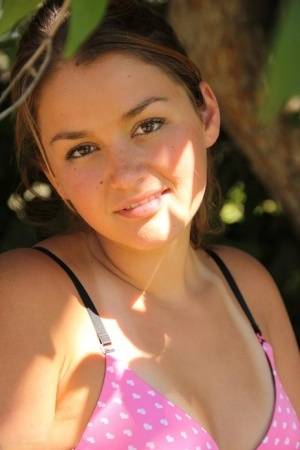 Petite amateur Allie Haze shows her tan lined body in the shade of a tree on clubgf.com