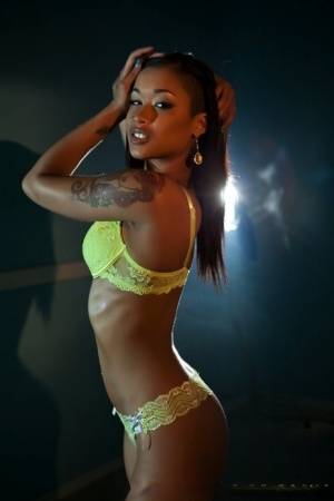 Sexy ebony Skin Diamond sheds yellow hot lingerie to pose naked on the stage on clubgf.com
