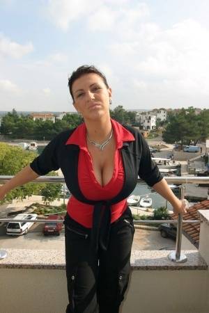 Solo model Kora Kryk touts her knockers on a balcony before dressing for work on clubgf.com