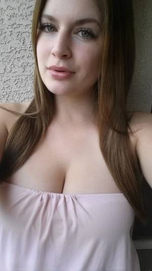 Plump amateur Danielle takes topless and clothed selfies around the house on clubgf.com