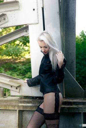 European teen Adelina White takes a pee on trestle bridge in black stockings on clubgf.com