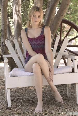 Teen first timer Lena Anderson vaunts her lithe body under a tree outside on clubgf.com