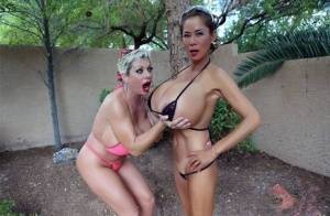 Big titted older women Claudia Marie and Minka kiss outdoors in skimpy bikinis on clubgf.com