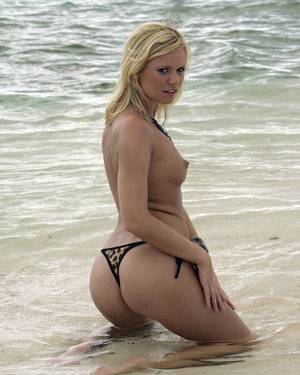 Sexy blonde models a skimpy thong during an ocean solo shoot on clubgf.com
