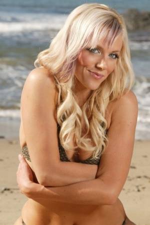 Blonde beauty Amy models on a sandy beach in her bikini on clubgf.com