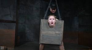Blonde girl Odette Delacroix is made to suck a black cock with head in stocks on clubgf.com