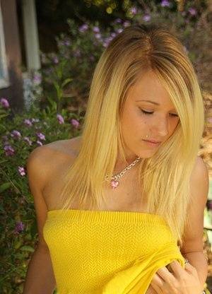 Blonde amateur Teagan bares her A-cup tits in a yard as she gets totally naked on clubgf.com
