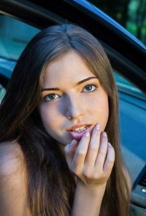 Beautiful teen girl models in the nude on passenger seat of car with door open on clubgf.com