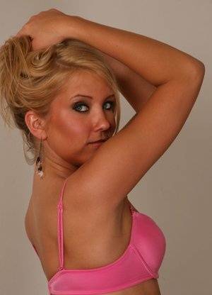 Blonde amateur Jocalynn piles up her hair before getting naked on a bed on clubgf.com
