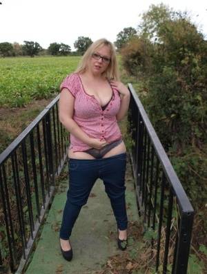 Amateur BBW Sindy Bust exposes her big boobs and twat on a countryside bridge on clubgf.com